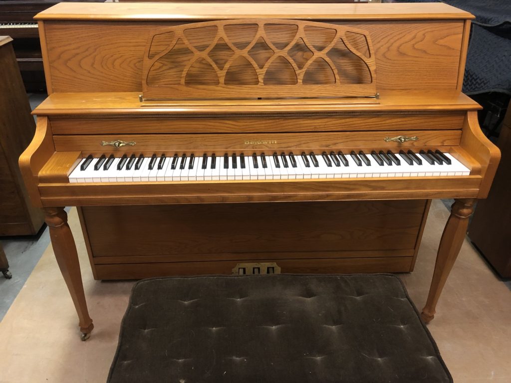 Baldwin Walnut Upright piano straight on