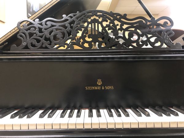 Steinway Model O grand piano keys and beautiful ornate music rest