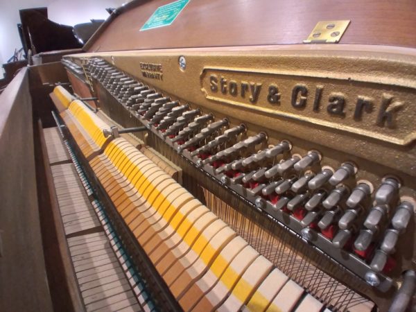 Story and Clark upright piano soundboard tuning pins close up view