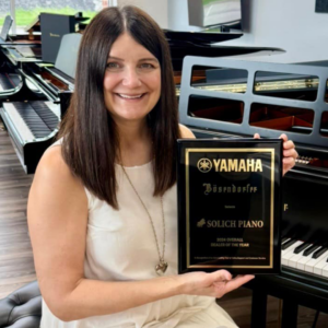 Kamaron Halleron with Yamaha National Dealer of the Year Award at Solich Piano Pittsburgh