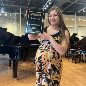 Lillia Baker with Yamaha National Dealer of the Year Award at Solich Piano Columbus