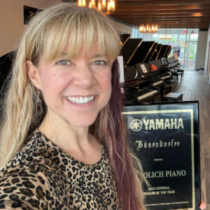 Linda Sproul with Yamaha National Dealer of the Year Award at Solich Piano Detroit